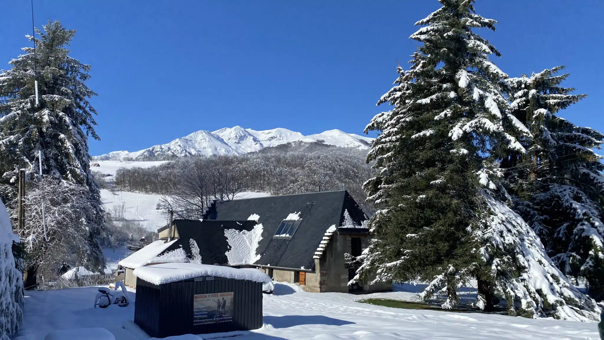 Hébergement - Maison Akasha Yoga Maison Akasha enneigée entre les sapins face aux sommets des Pyrénées